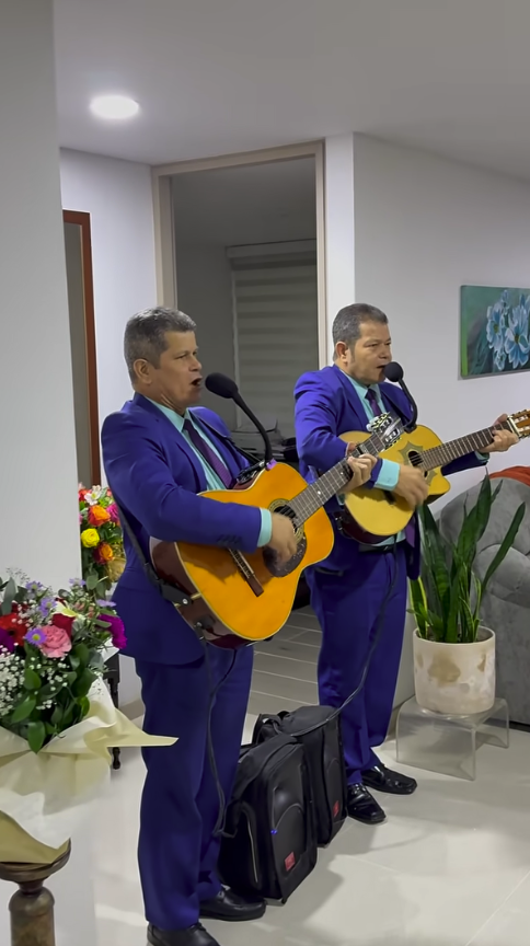 Dueto de cuerdas en Medellín: dos músicos interpretan serenata en vivo con guitarras.